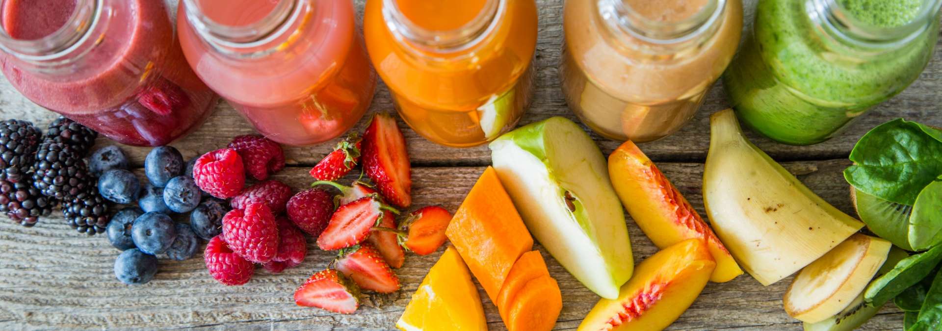 smoothies, fruits, and vegetables laid out on table